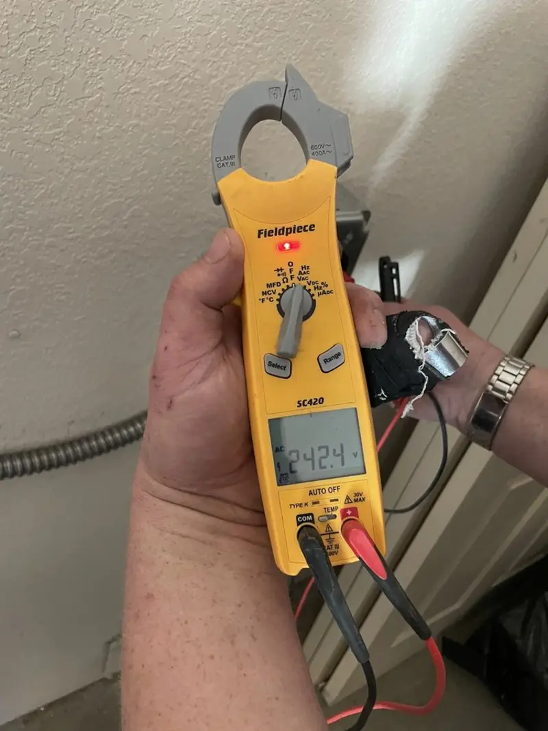 Voltage testing with clamp meter during Ceiling Fan Installation in Indianola